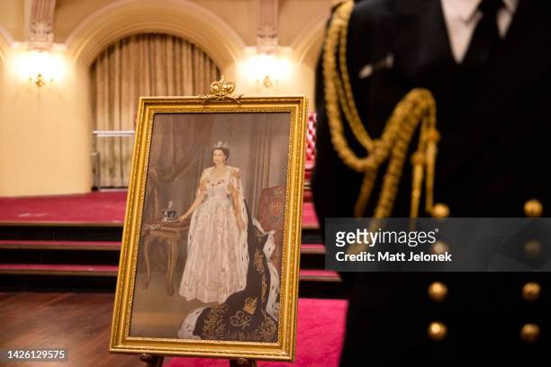 Portrait of the late Queen Elizabeth II is seen behind an Aide-de-Camp at Government House on September 22, 2022 in Perth, Australia. Australians...