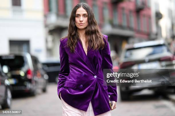 Erika Boldrin wears a dark purple velvet oversized jacket, pale pink puffy baggy pants, outside Alberta Ferretti, during the Milan Fashion Week -...