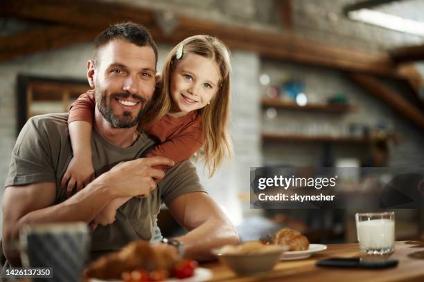 feliz padre soltero e hija abrazados en casa. - affectionate fotografías e imágenes de stock