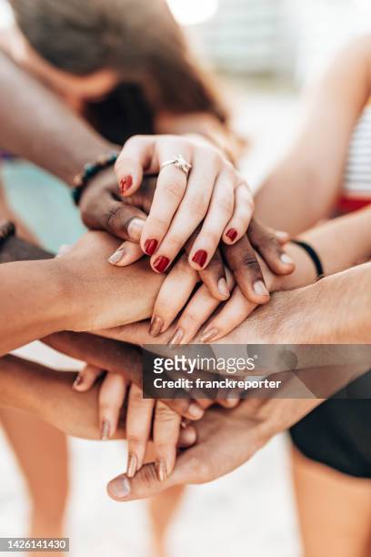 stack of hands of friends - hand stack stock pictures, royalty-free photos & images