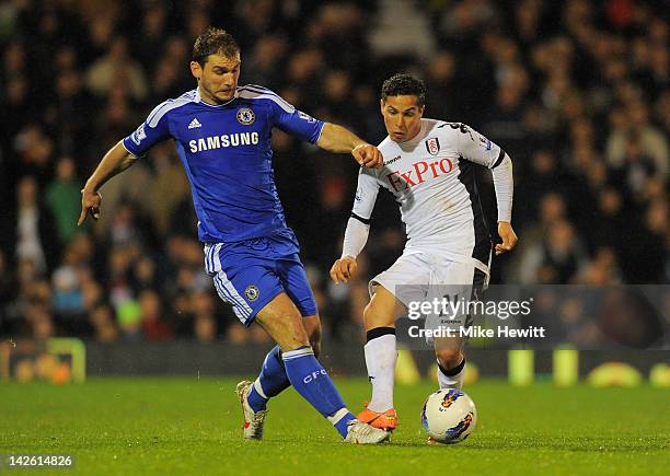 Branislav Ivanovic of Chelsea and Kerim Frei of Fulham compete for the ball during the Barclays Premier League match between Fulham and Chelsea at...