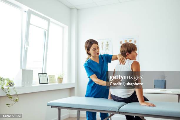 chiropractic treatment, back pain relief. - osteopath stock pictures, royalty-free photos & images