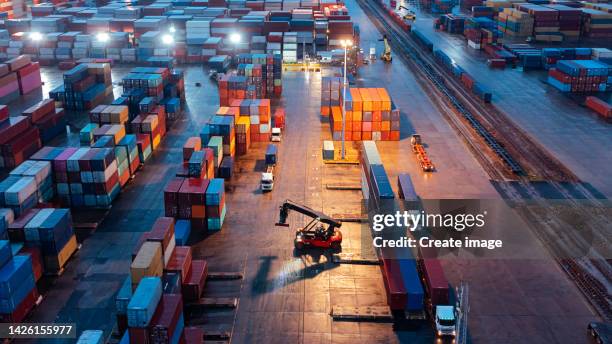 aerial view forklift handling container load to container truck at container warehouse for business logistics, import export, shipping or freight transportation. - transporte de carga fotografías e imágenes de stock
