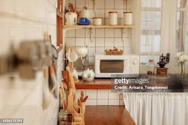 minimal style kitchen with warm tones - microwave oven stockfoto's en -beelden