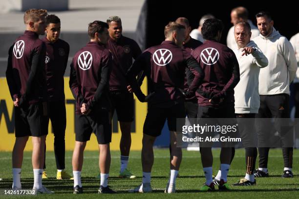 Head coach Hans-Dieter Flick talks to players during a Germany training session at DFB-Campus on September 22, 2022 in Frankfurt am Main, Germany.