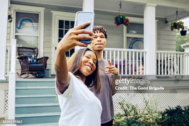 young woman taking selfie with friend by house - photographing garden stock pictures, royalty-free photos & images