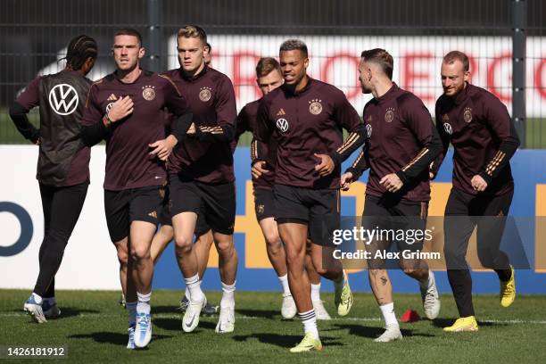 Robin Gosens, Matthias Ginter, Lukas Nmecha and teammates exercise during a Germany training session at DFB-Campus on September 22, 2022 in Frankfurt...