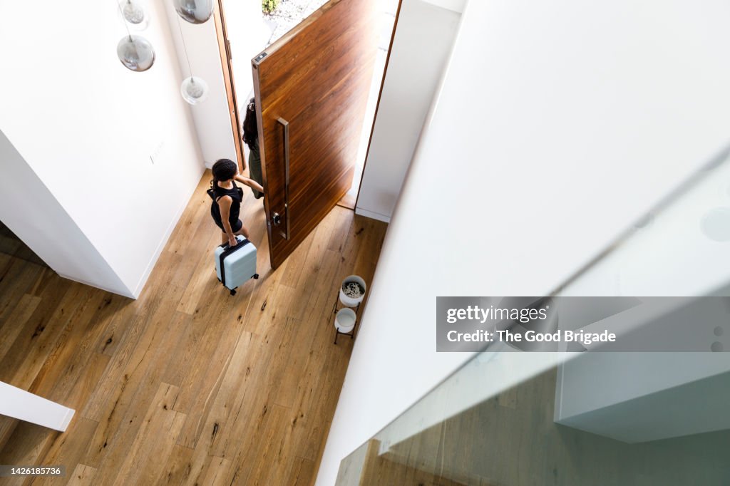 Female friends leaving vacation rental home