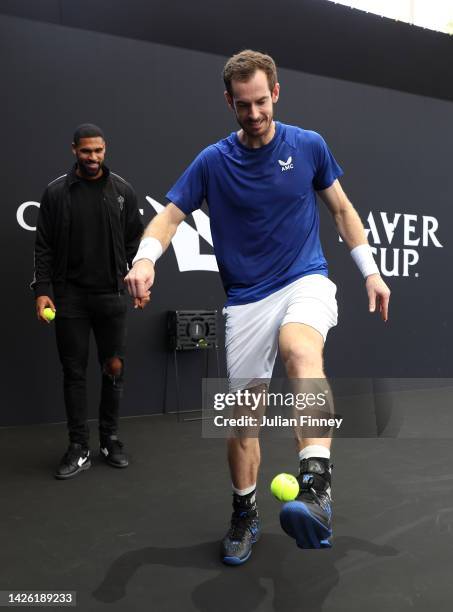 Andy Murray of Team Europe plays football with a tennis ball on the practice court as Ruben Loftus-Cheek of Chelsea looks on on September 22, 2022 in...