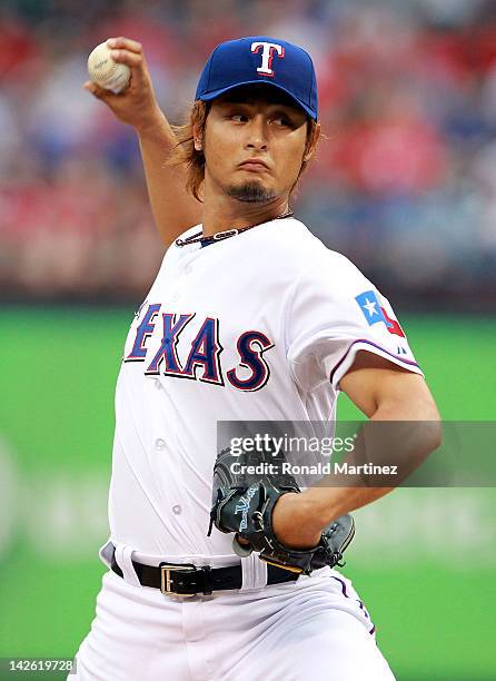 Yu Darvish of the Texas Rangers throws out the first pitch against Chone Figgins of the Seattle Mariners in the first inning at Rangers Ballpark in...