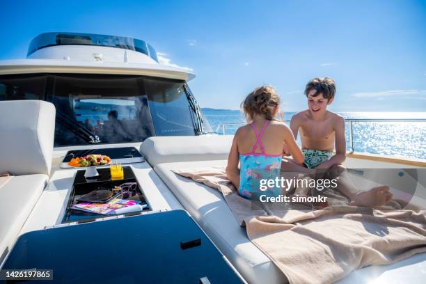 children playing on yacht - teen boy barefoot stock pictures, royalty-free photos & images