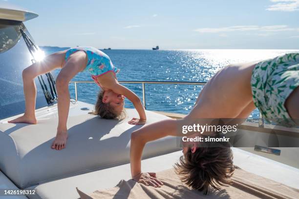 children bending over backwards - teen boy shorts stock pictures, royalty-free photos & images