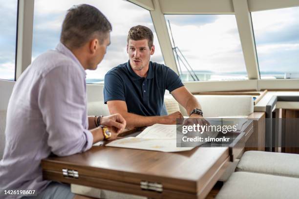 skipper discussing map - boat captain stock pictures, royalty-free photos & images