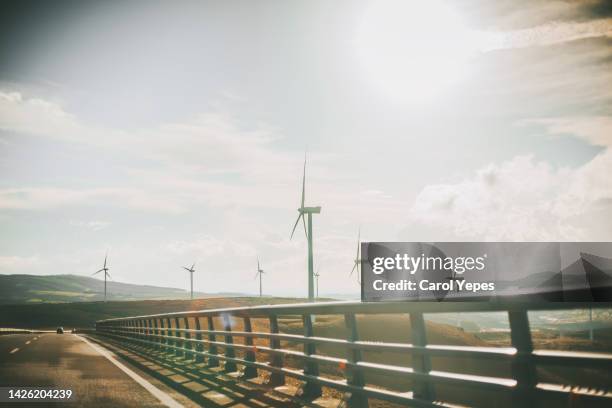 environment and wind turbine  in a idyllic landscape with sunlight - paper windmill stock-fotos und bilder