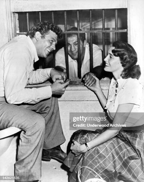 Retired heavyweight champion Rocky Marciano gets consoled on the set of 'A Face In The Crowd' by stars Andy Griffith and Patricia Neal, Hollywood,...