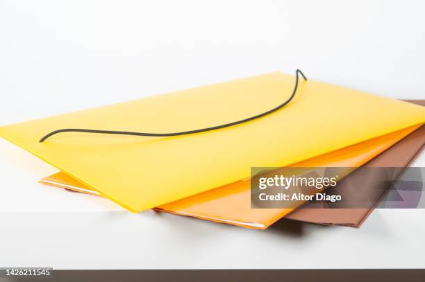 several folders on a table. school supplies. - manilla folder stock pictures, royalty-free photos & images