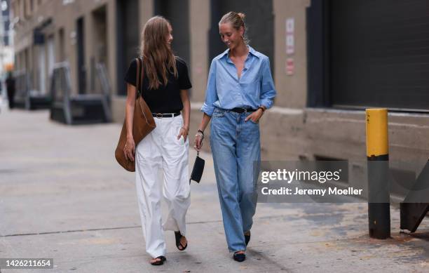 Guest is seen wearing a black t-shirt, black leather belt, white wide leg pants, brown leather bag and black sandals; A guest is seen wearing blue...