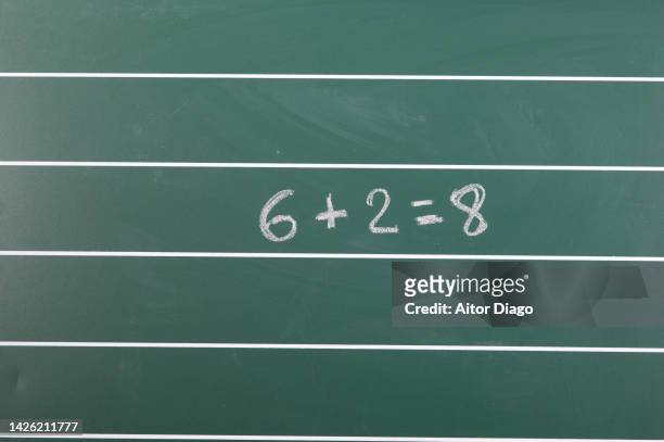 a classroom blackboard with a sum written on its surface in chalk. - number 2 pencil stock pictures, royalty-free photos & images
