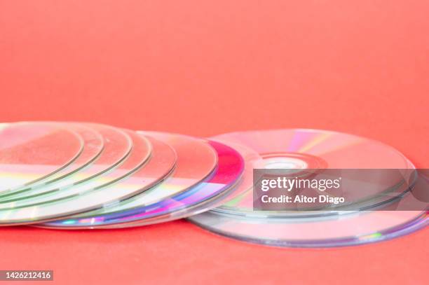 a pile of dvds on red paper. . school supplies. - class rom stock pictures, royalty-free photos & images