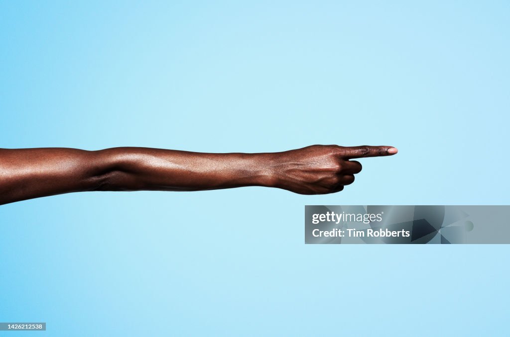 Woman pointing with coloured background
