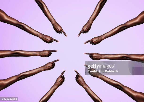 circle of womans arms pointing - repreensão imagens e fotografias de stock