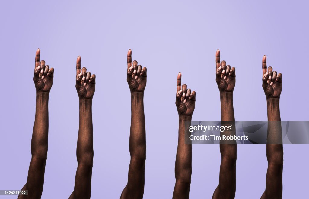Arms being held up with extended finger