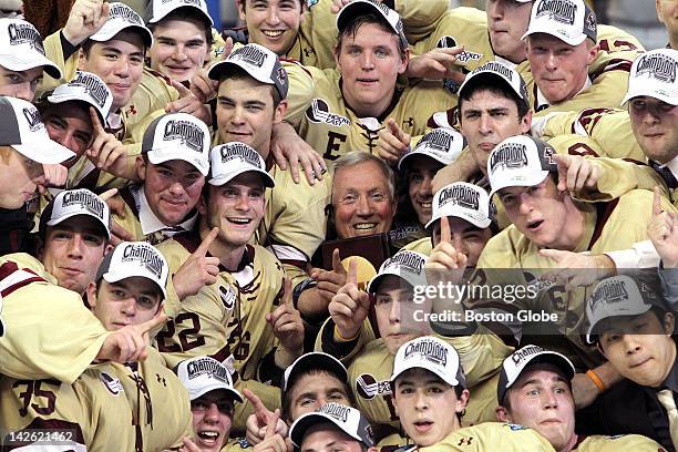 Boston College men's ice hockey head coach Jerry York and his Eagles celebrate with the national championship trophy after defeating Ferris State in...