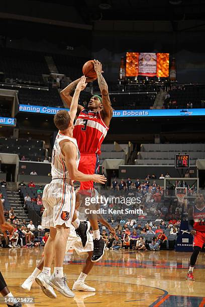 James Singleton of the Washington Wizards shoots against Matt Carroll of the Charlotte Bobcats at the Time Warner Cable Arena on April 9, 2012 in...
