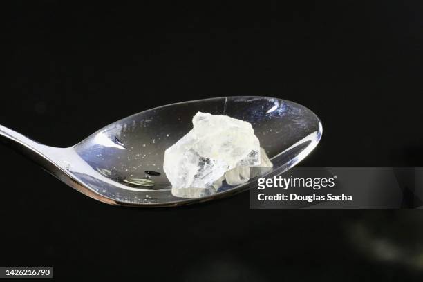 crystal meth being cooked in a spoon - heroïne stockfoto's en -beelden