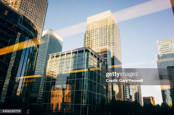 low angle view of skyscrapers in canary wharf, london - sunset on canary wharf stock-fotos und bilder