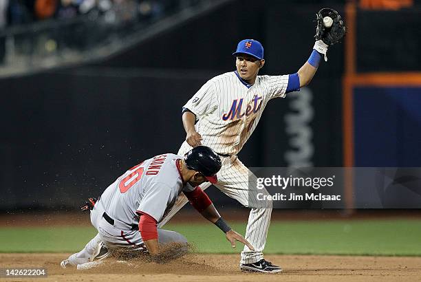 Ruben Tejada of the New York Mets holds the ball after forcing out Ian Desmond of the Washington Nationals to end the top of the ninth inning at Citi...