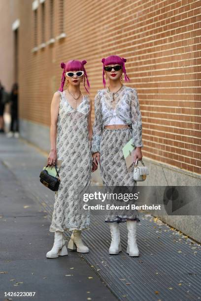 Ami wears white sunglasses, a gold large chain necklace, a gold large Fendi handbag, a beige with pale gray print pattern V-neck / sleeveless long...