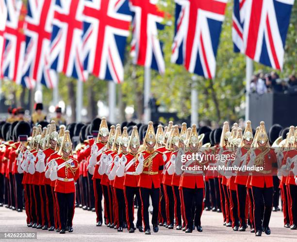 Dismounted detachment of The Life Guards of the Household Cavalry lead the ceremonial procession transporting Queen Elizabeth II's coffin, on a gun...