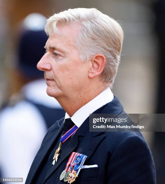 Sir Clive Alderton walks behind Queen Elizabeth II's coffin as it is transported on a gun carriage from Buckingham Palace to The Palace of...