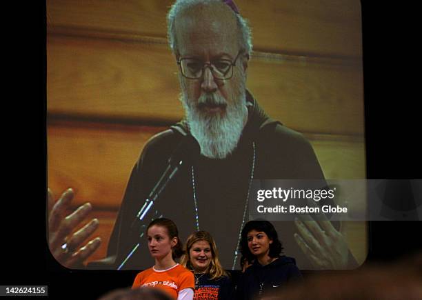 Catholic teens listen to Bishop Sean O'Malley as his image is projected on a screen during the Archdiocese of Boston Catholic Youth Rally held at...