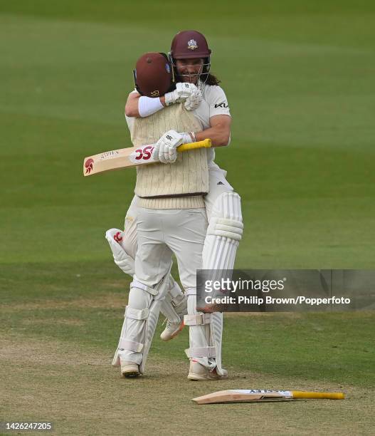 Rory Burns and Ryan Patel of Surrey embrace after Surrey won the LV= Insurance County Championship match between Surrey and Yorkshire at the Micky...