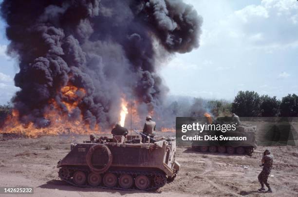 As part of Operation Cedar Falls, armored personnel carriers from the 1st squadron 4th Cavalry burn field in the so-called Iron Triangle region,...