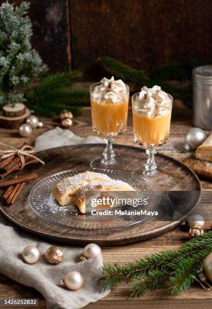 christmas dessert apricot strudel cake with advocaat eggnog and whipped cream in rustic wood kitchen - vispgrädde bildbanksfoton och bilder