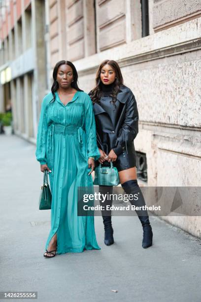 Guest wears silver earrings, a green long sleeves / embossed pattern silk long dress, a dark green shiny leather handbag from Alberta Ferretti, black...