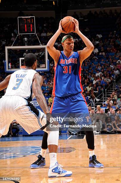 Rodney Stuckey of the Detroit Pistons protects the ball from Earl Clark of the Orlando Magic during the game between the Detroit Pistons and the...