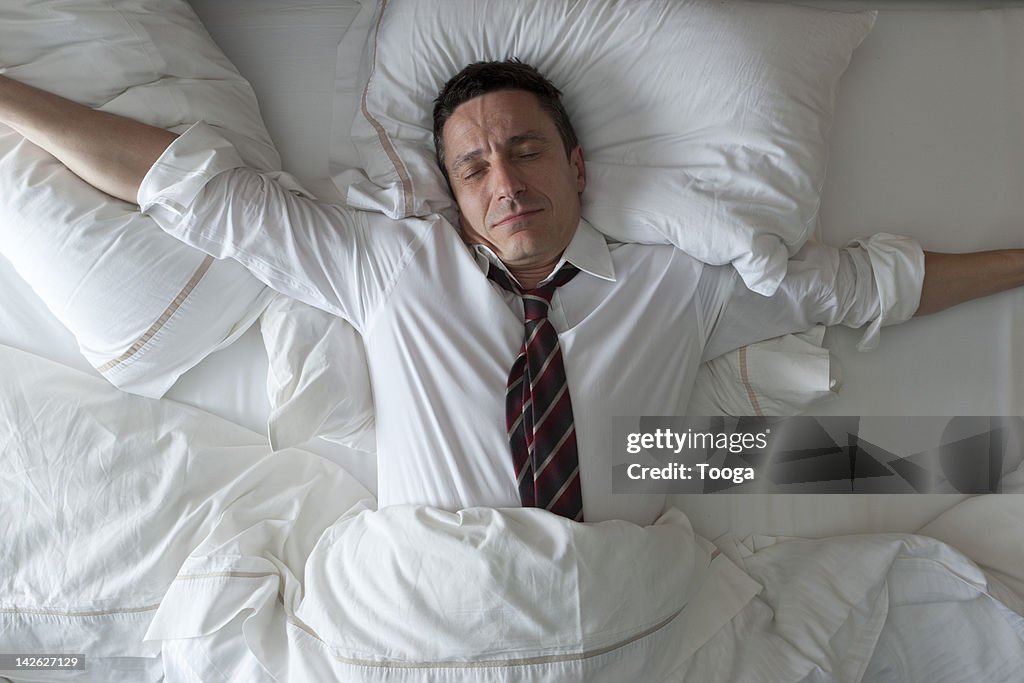 Businessman waking up with clothes on