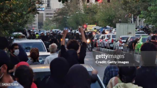 People gather in protest against the death of Mahsa Amini along the streets on September 19, 2022 in Tehran, Iran. 22-year-old Mahsa Amini fell into...