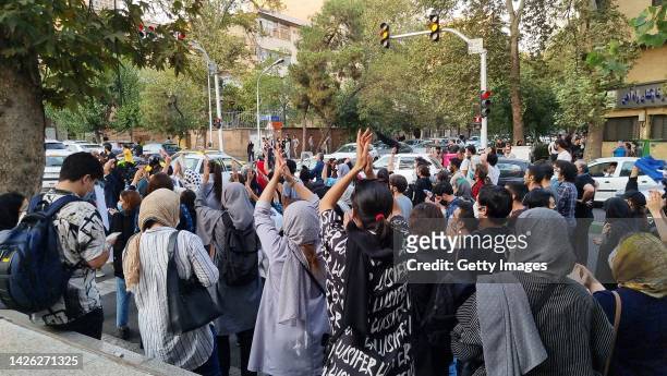 People gather in protest against the death of Mahsa Amini along the streets on September 19, 2022 in Tehran, Iran. 22-year-old Mahsa Amini fell into...