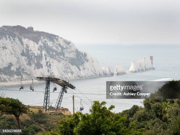 the needles, a group of chalk stacks on the west tip of the isle of white, uk with the chairlift down to alum bay. - isle of wight needles stock pictures, royalty-free photos & images