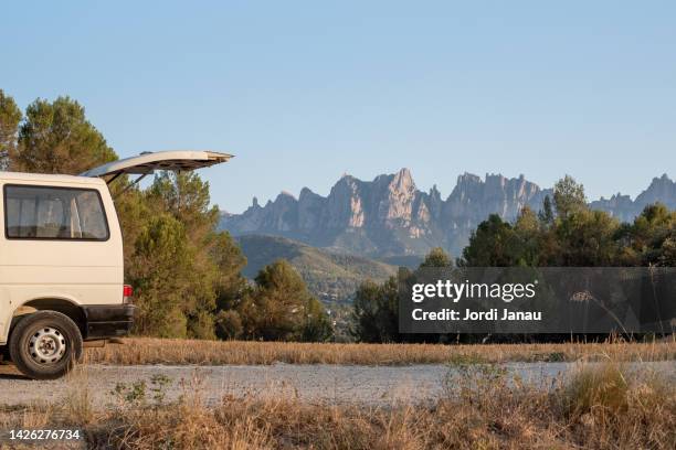 landscape of the mountains of montserrat with a camper van with the tailgate open - montserrat stock pictures, royalty-free photos & images