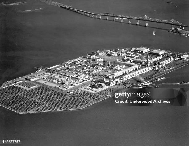 Aerial view of Treasure Island during the Golden Gate International Exposition, San Francisco, California, 1939. The San Francisco Oakland Bay Bridge...