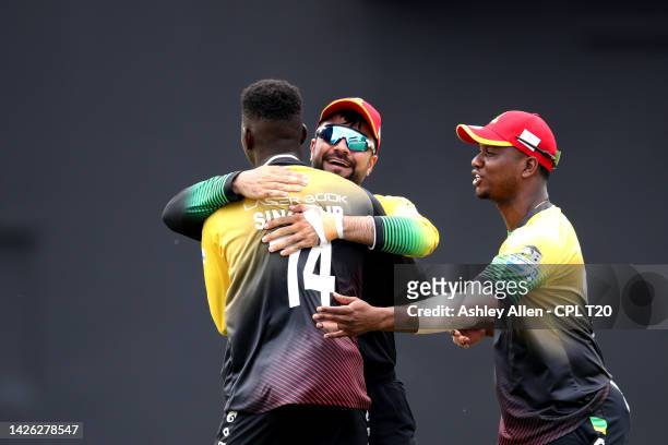 Kevin Sinclair, Rashid Khan and Evin Lewis of St Kitts & Nevis Patriots celebrate the wicket of Colin Munro of Trinbago Knight Riders during the...