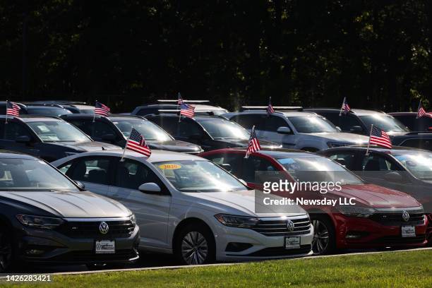Vehicles for sale on a Volkswagen dealership lot in St. James, New York on Sept. 21, 2022.