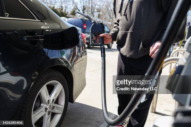 Customer fills up his vehicle's gas tank at the Sunoco gas station in Hauppauge, New York on March 11, 2022.