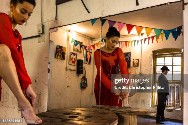 Tango dancers, Iara Duarte, 22 and Jesus Paez, 34 in final preparations for a Tango performance at "La Catedral del Tango" social club in Buenos...